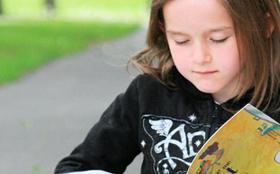 Albert Lea student reading outside